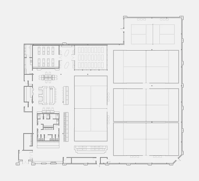 Floor plan showing a large open seating area flanked by service spaces and courtyard volumes