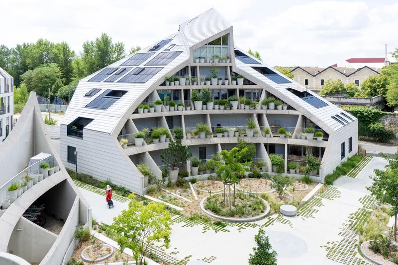 Aerial view of the courtyard with circular planters and the planted facade encircling the central paved space