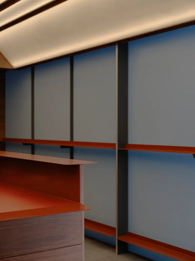 Close-up of the copper ledge intersecting vertical timber mullions on the translucent glass wall
