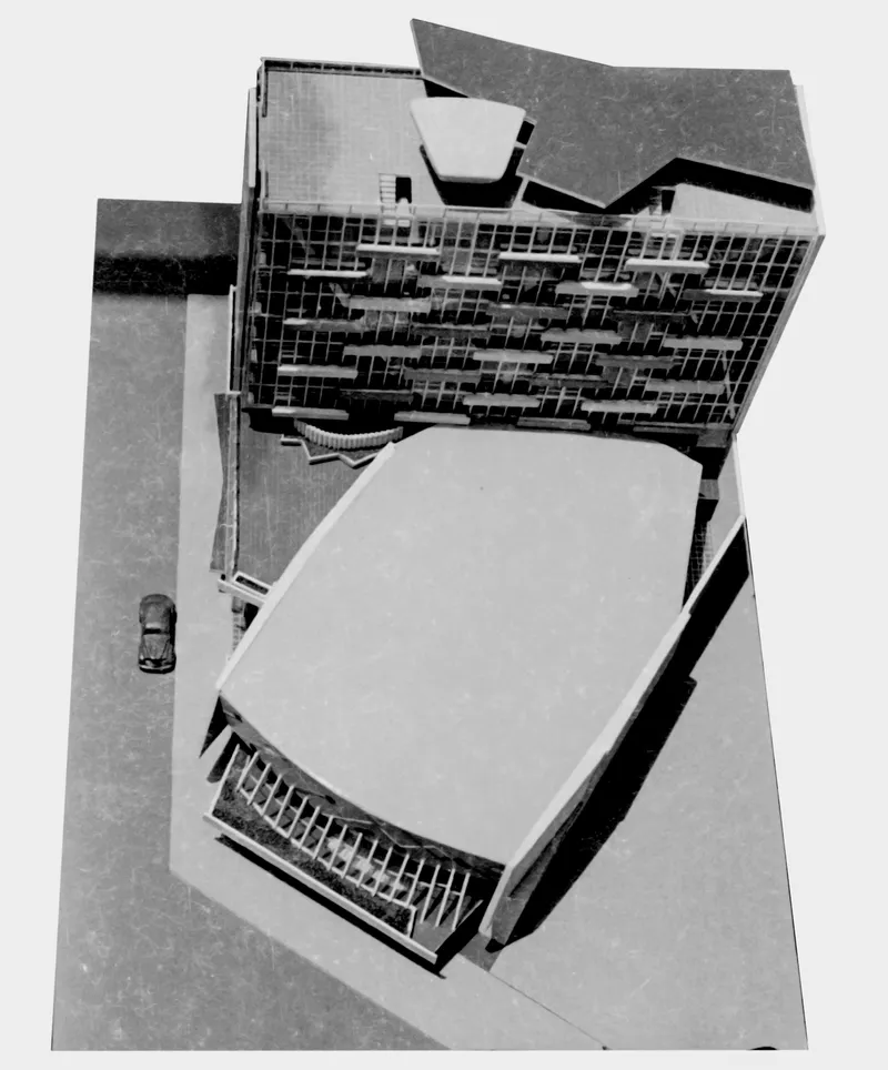 Aerial view of a pentagonal roof canopy over an auditorium with a car parked nearby