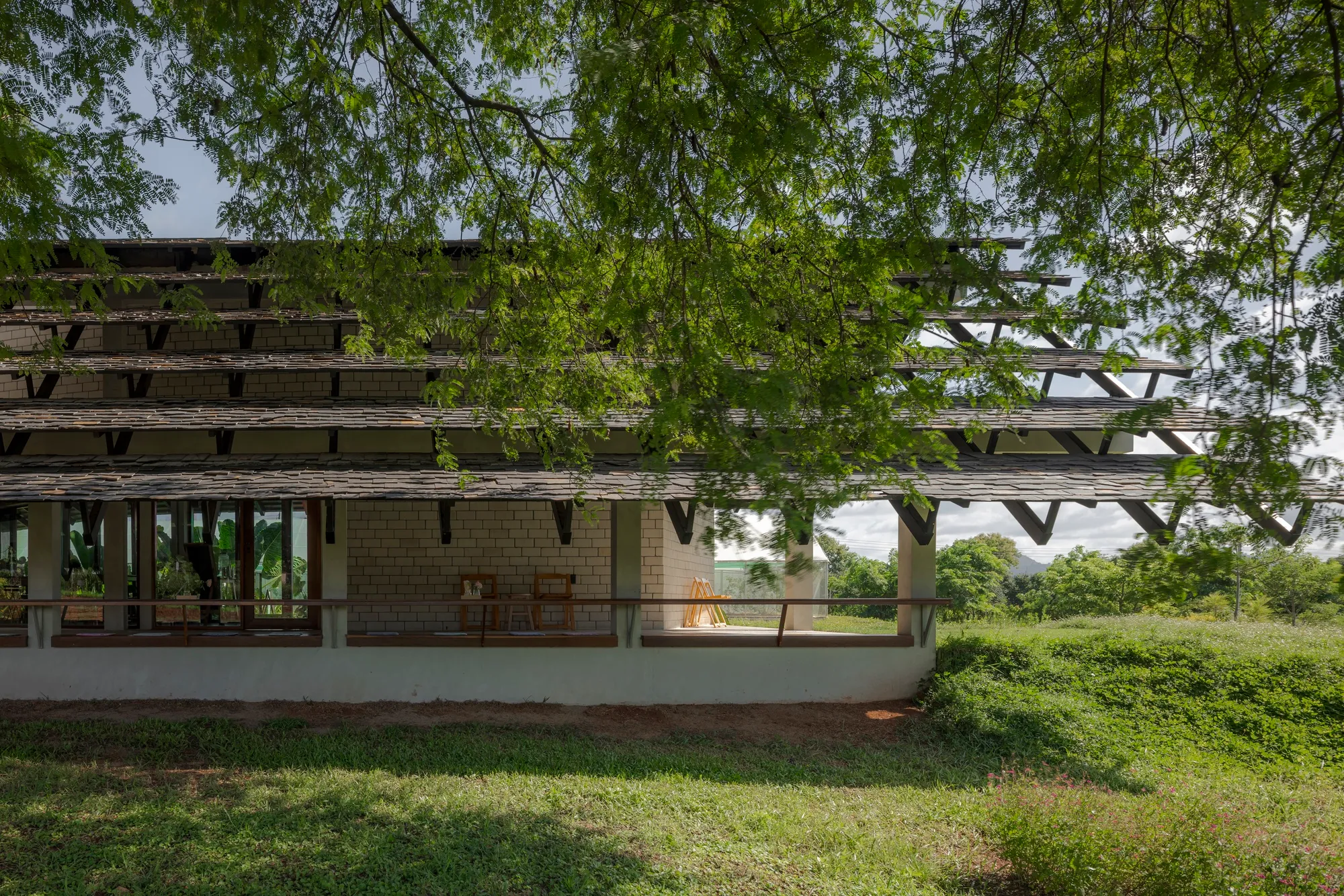 SO Splits a Gable Roof in Two to Let a Tamarind Canopy Define a Thai Farmshop