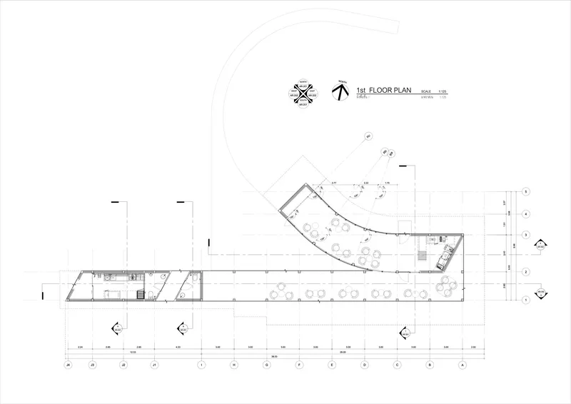 First floor plan drawing displaying an angled linear bar with curved end and outdoor seating area
