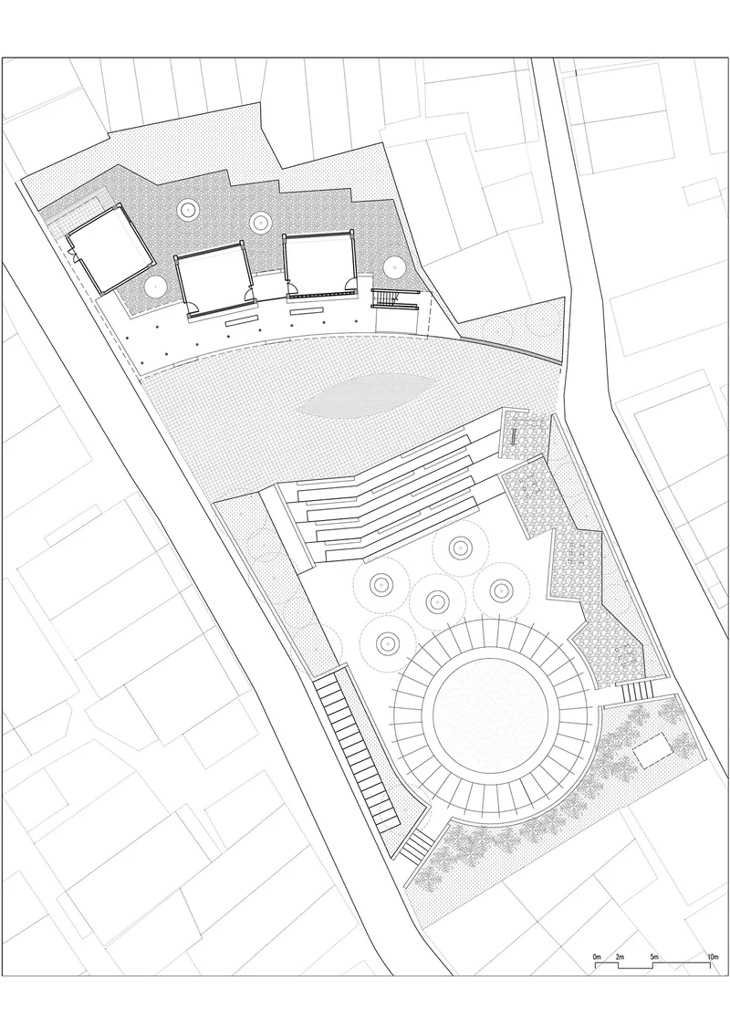 Site plan drawing showing buildings, a circular courtyard, stepped terraces, and surrounding street grid