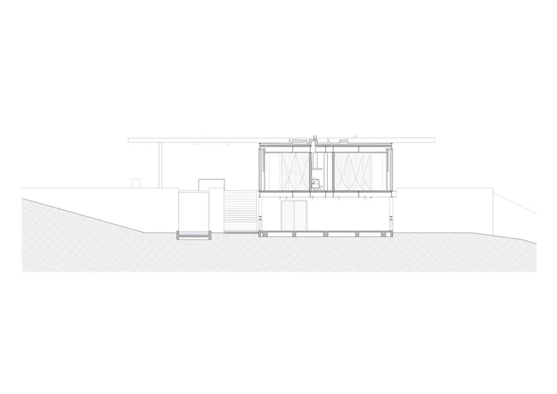 Section drawing showing a two-story volume with a flat roof canopy partially embedded in sloping terrain