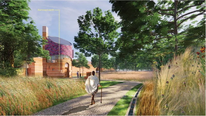 Forest pathway leading toward the chapel through native grasses and rammed-earth architecture.
