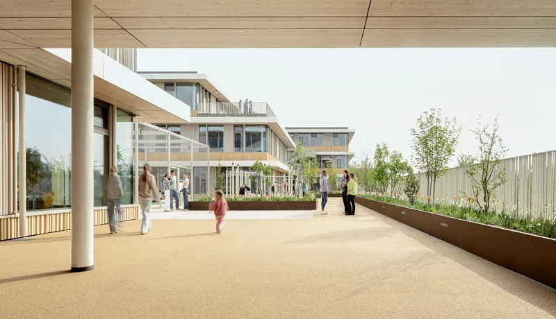 Rooftop terrace with planted beds, timber columns, and people gathering under an overcast sky