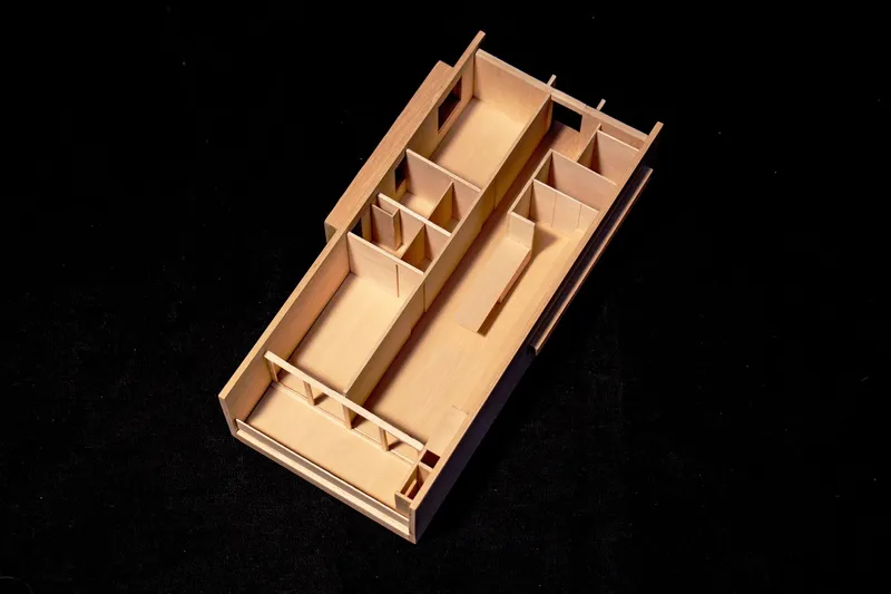 Sectional model revealing interior room divisions and partition walls in light wood