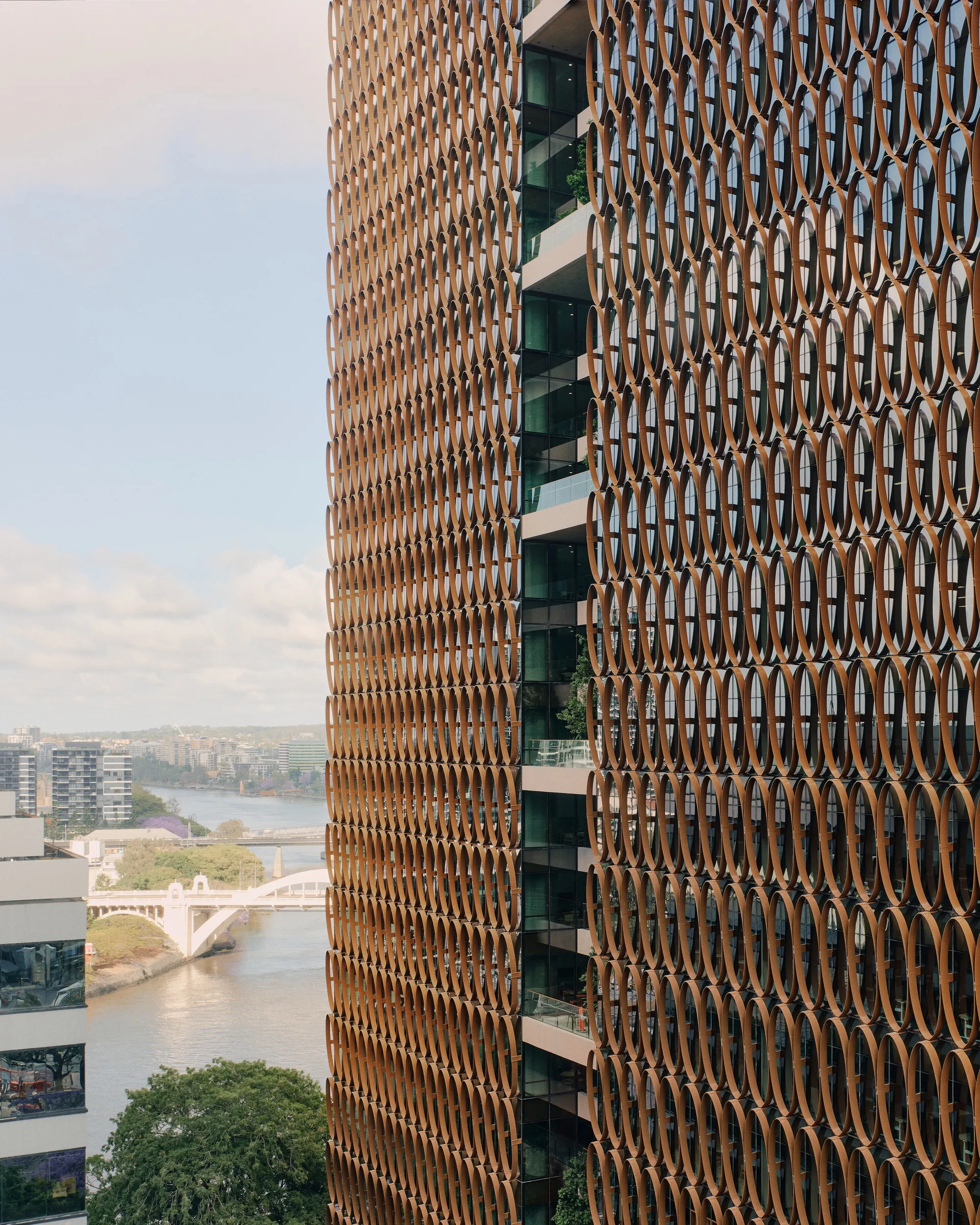 Hassell, REX, and Richards and Spence Wrap a Brisbane Tower in a Climate-Tuned Copper Veil
