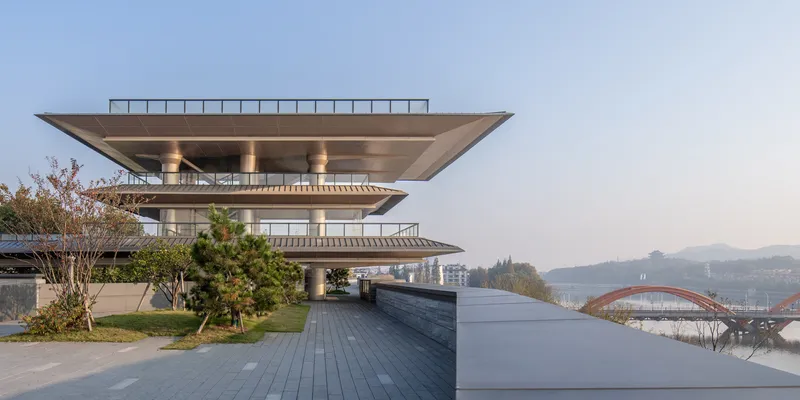 Cantilevered roof terraces overlooking the reflecting pool and distant mountains in clear daylight
