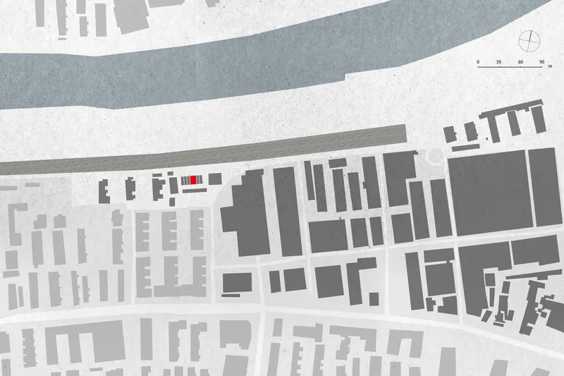 Site plan drawing showing a rectangular building footprint highlighted in red within the urban block