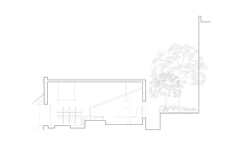 Section drawing showing interior spaces with stairs and an adjacent courtyard tree
