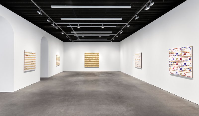 Gallery room with white walls, black exposed joist ceiling and polished concrete floor