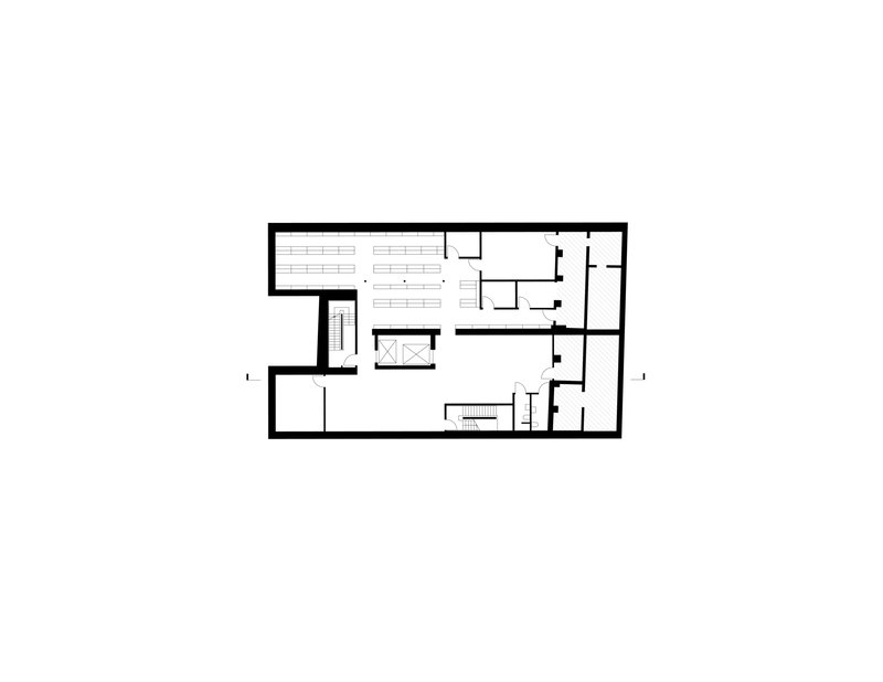 Floor plan drawing showing an office level with workstations, meeting rooms, and central stair