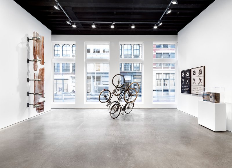 Gallery space with tall arched windows overlooking the street and polished concrete floor
