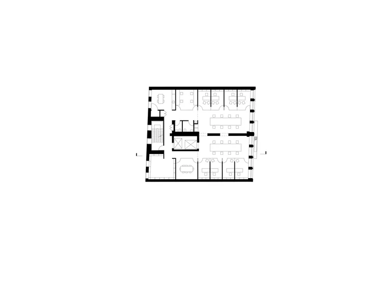 Floor plan drawing showing an office floor with enclosed meeting rooms and open workspace zones