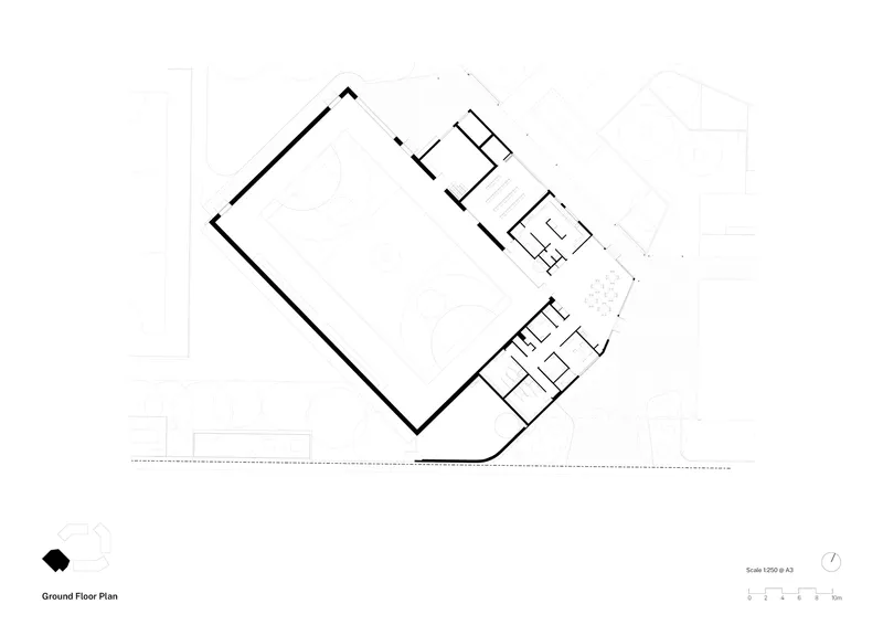 Ground floor plan drawing showing a large rectangular hall with support rooms clustered at opposite corners