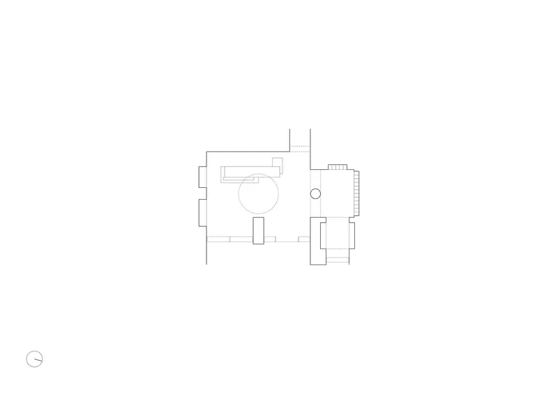 Floor plan drawing showing two connected rooms with circular element and north arrow indicator