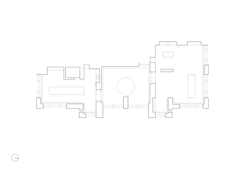 Floor plan drawing showing three rooms linked around a central circular element with north arrow
