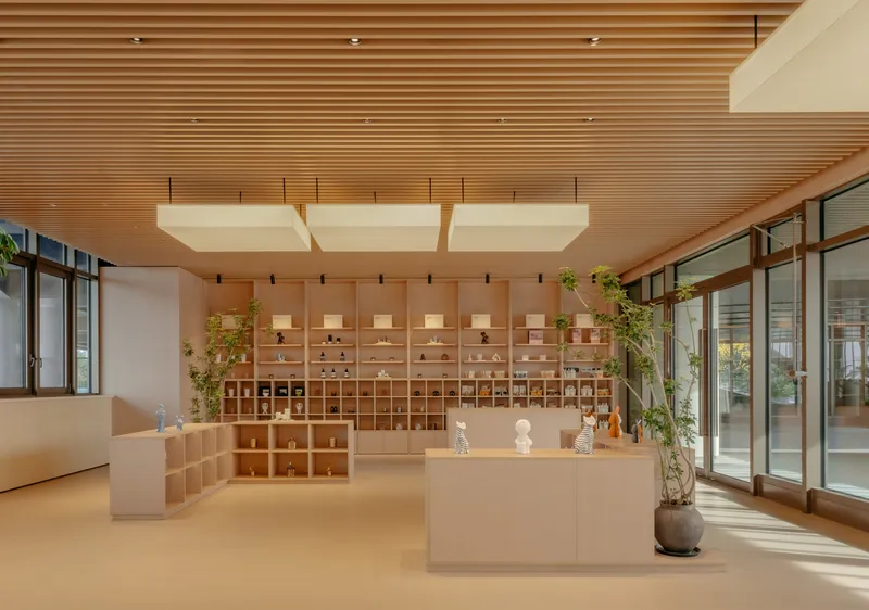 Reception area with horizontal timber slat ceiling and cubby storage wall beneath suspended white light panels
