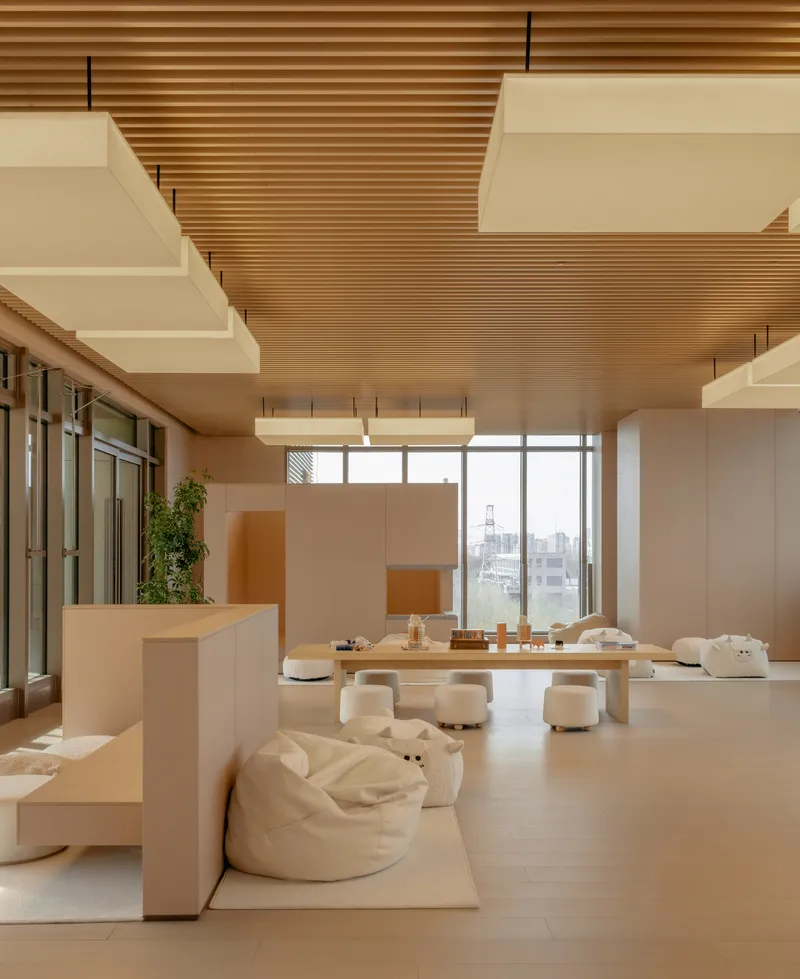Lounge area with beanbag seating and architectural model on display table overlooking the city skyline