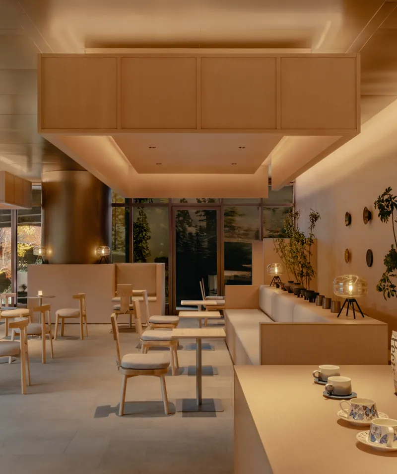 Seating area with recessed ceiling panels, banquette seating and glass doors reflecting dusk exterior
