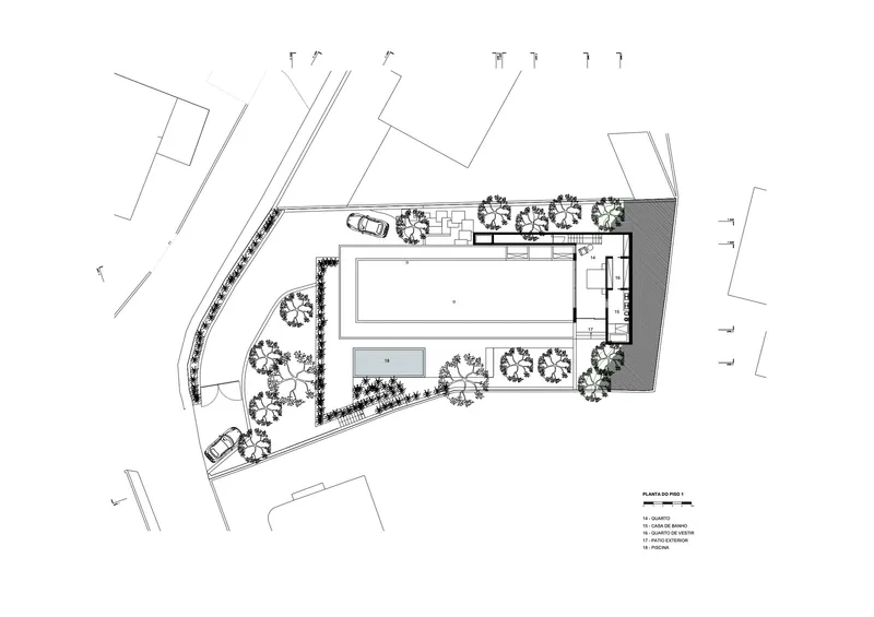 Site plan drawing showing a rectangular pool, adjacent secondary volume, and perimeter landscaping with trees