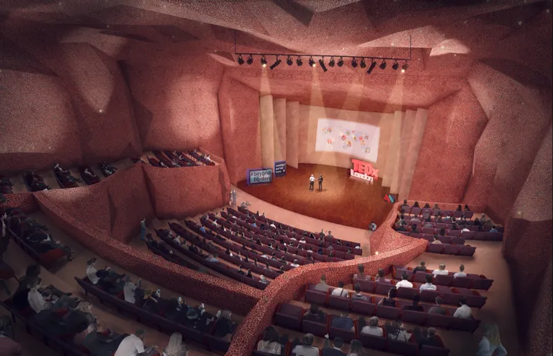 Immersive auditorium design with sculptural red interiors and tiered seating for cultural performances.