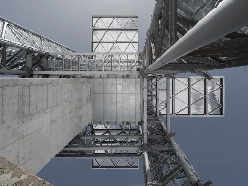 Upward view of the steel lattice structure with concrete base and triangulated glass panels