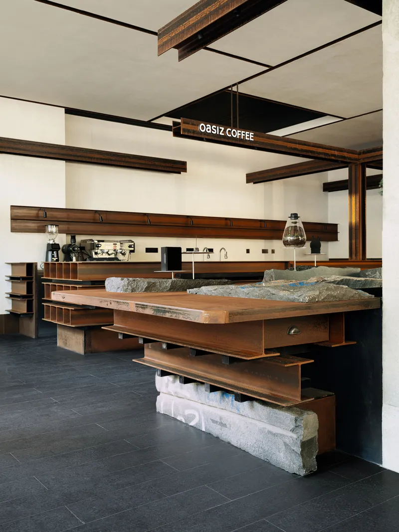Timber counter with exposed shelving and rough stone base beneath suspended ceiling beams