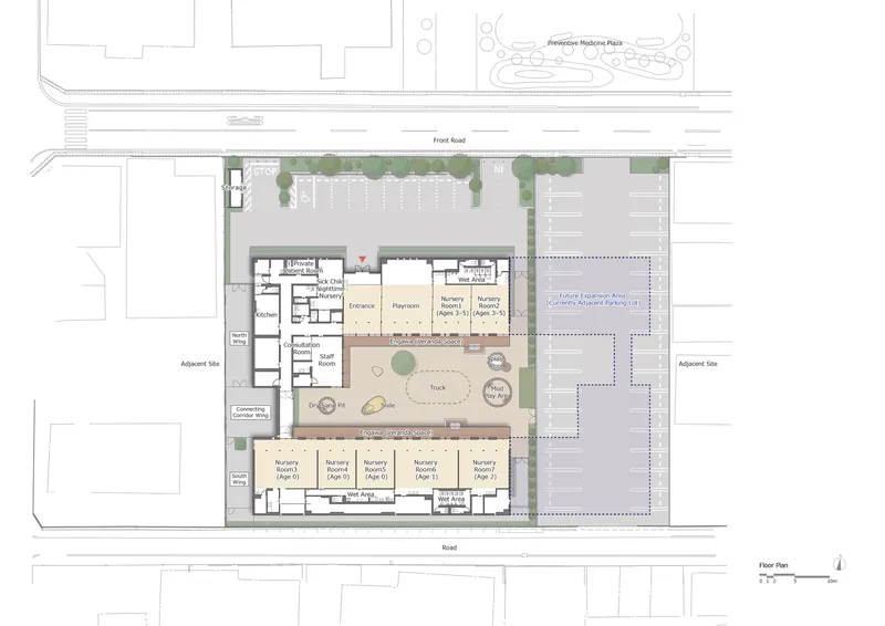 Floor plan drawing with central courtyard surrounded by classroom wings and adjacent parking area