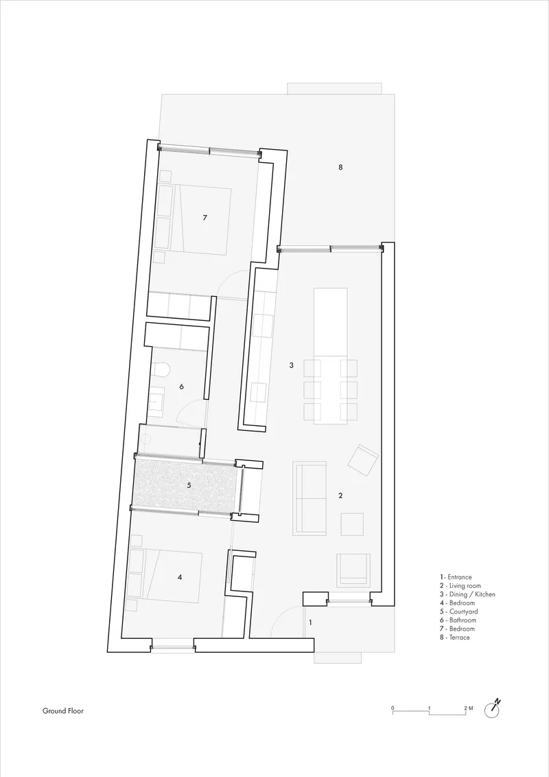 Ground floor plan drawing showing entrance, living room, kitchen, bedroom, and courtyard spaces