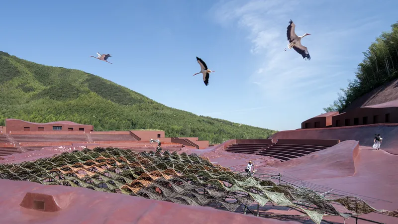Amphitheatre seating and planted terraces with three cranes flying overhead in blue sky