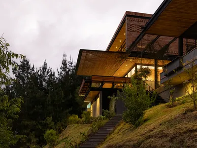 Estudio29 Cantilevers a Brick and Timber House Over the Andean Slope Toward Guagualzhumi