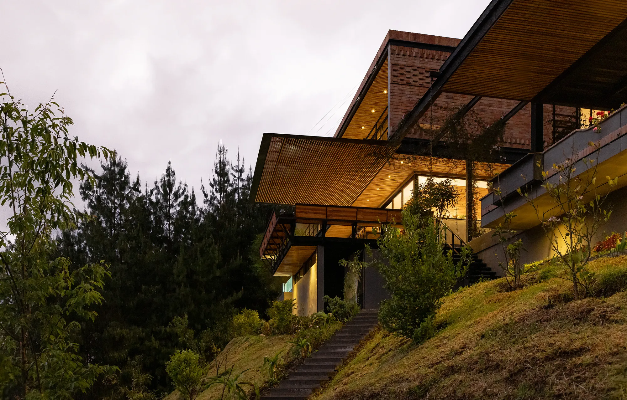 Estudio29 Cantilevers a Brick and Timber House Over the Andean Slope Toward Guagualzhumi