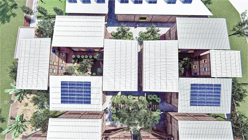 Aerial view of clustered refugee housing with solar roofs and shared courtyards.