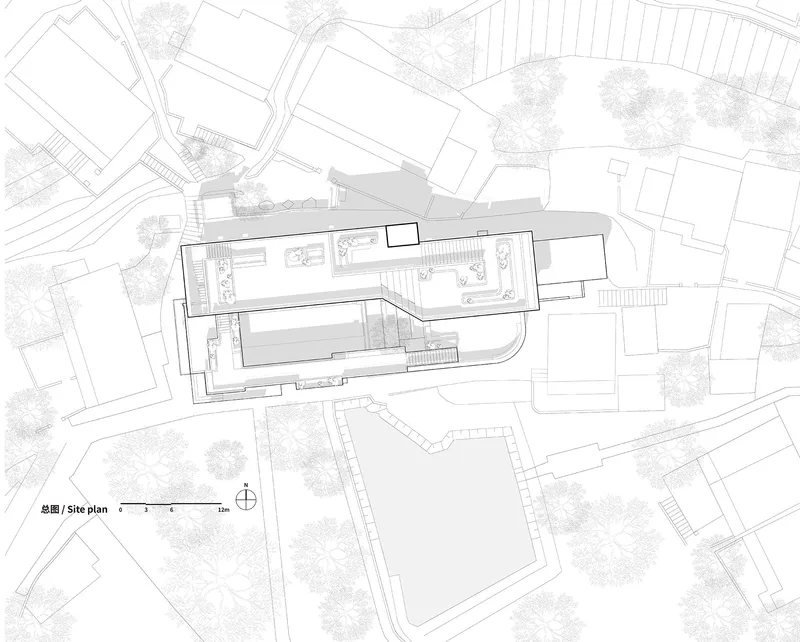 Site plan drawing showing an angular building within a dense urban block with surrounding streets and trees