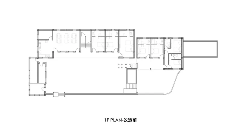 Floor plan drawing showing an L-shaped residential layout with multiple rooms and two staircases