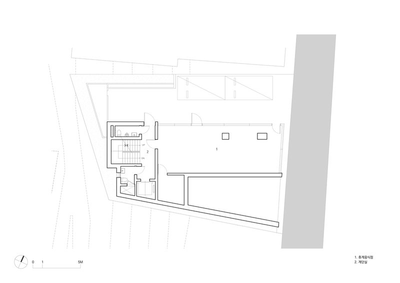 Floor plan drawing showing the main level with open interior and diagonal street edge
