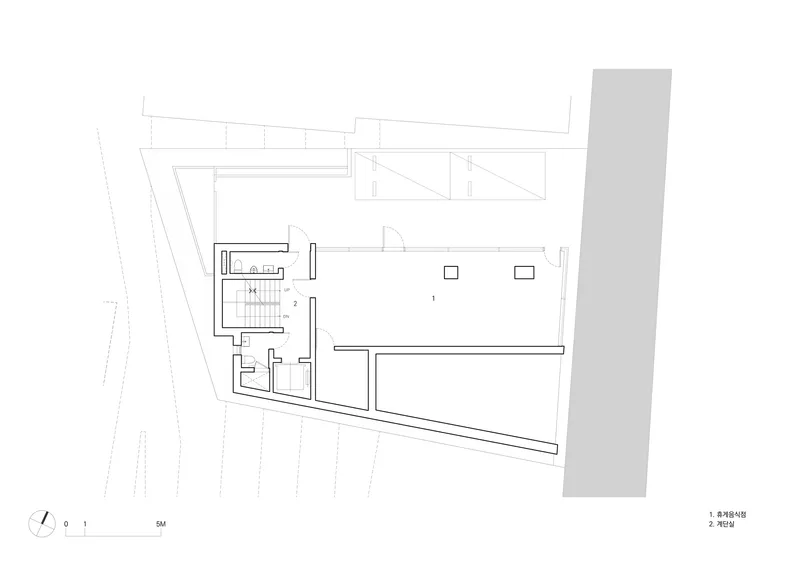 Floor plan drawing showing the main level with open interior and diagonal street edge