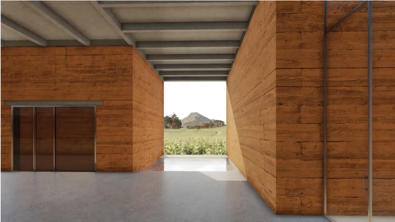 A narrow passage between massive earthen volumes carefully frames the vineyard and distant mountain landscape.