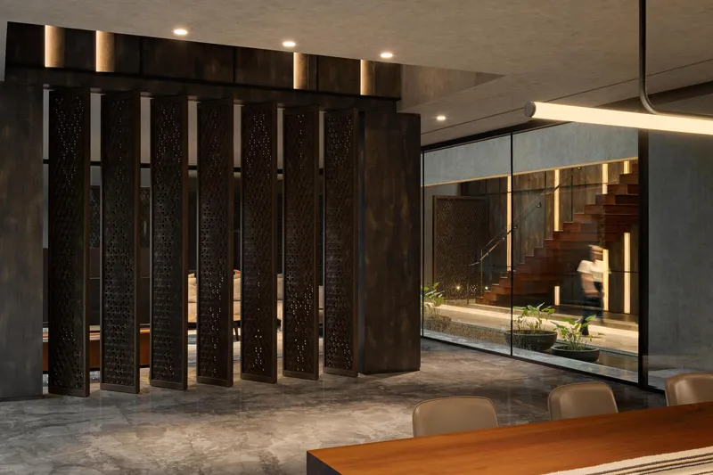 Freestanding dark timber screen panels with backlit vertical slots in the living space