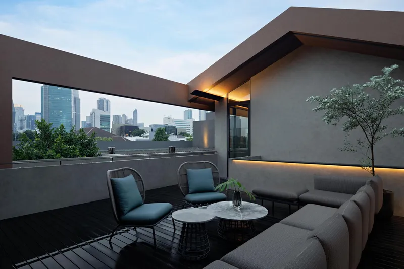 Rooftop terrace with concrete parapet framing views of the skyline at dusk