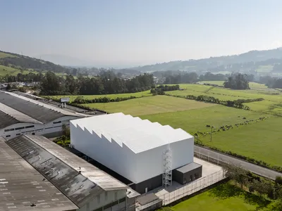 TEC Taller EC Stacks a Red Steel Office Inside a 23-Meter-Tall Andean Warehouse
