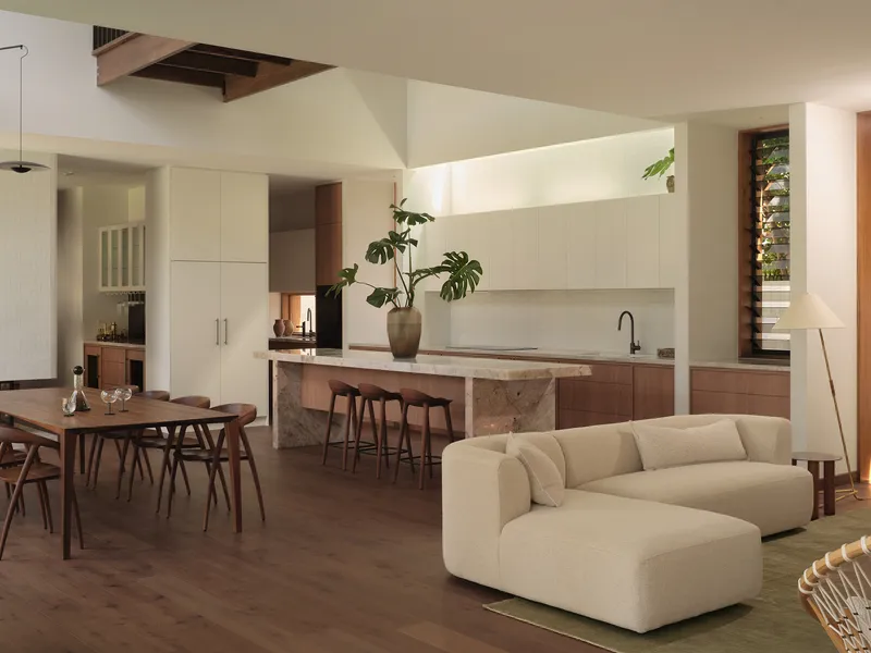 Kitchen and dining area with stone-clad island and skylight opening in the ceiling