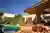 Dayala e Rafael Wraps a Goiânia Corner Lot in Stone and Muxarabi to Tame the Savanna Sun