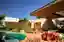 Dayala e Rafael Wraps a Goiânia Corner Lot in Stone and Muxarabi to Tame the Savanna Sun