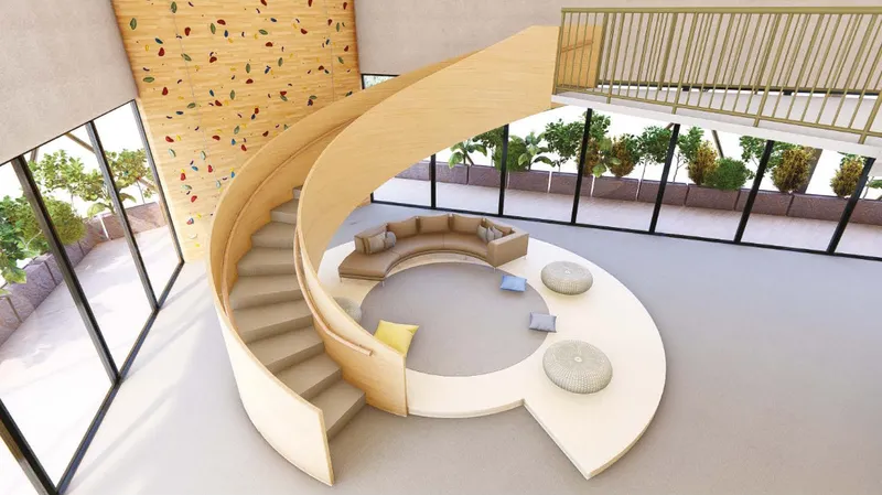 Curved staircases and informal seating transform circulation into a collaborative social space.