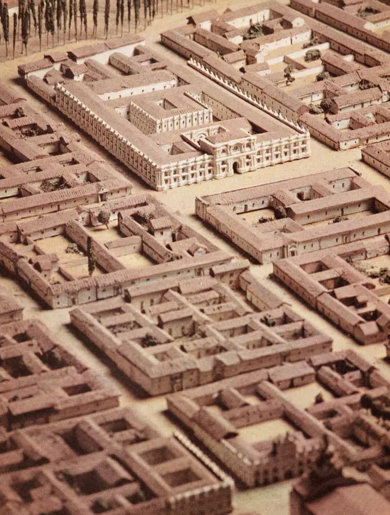 Physical model showing a multi-courtyard complex with perimeter buildings surrounding open quadrangles
