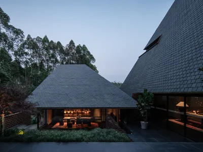 line+ and studio Scatter Steep-Roofed Dwellings Across a Red Valley in Yunnan