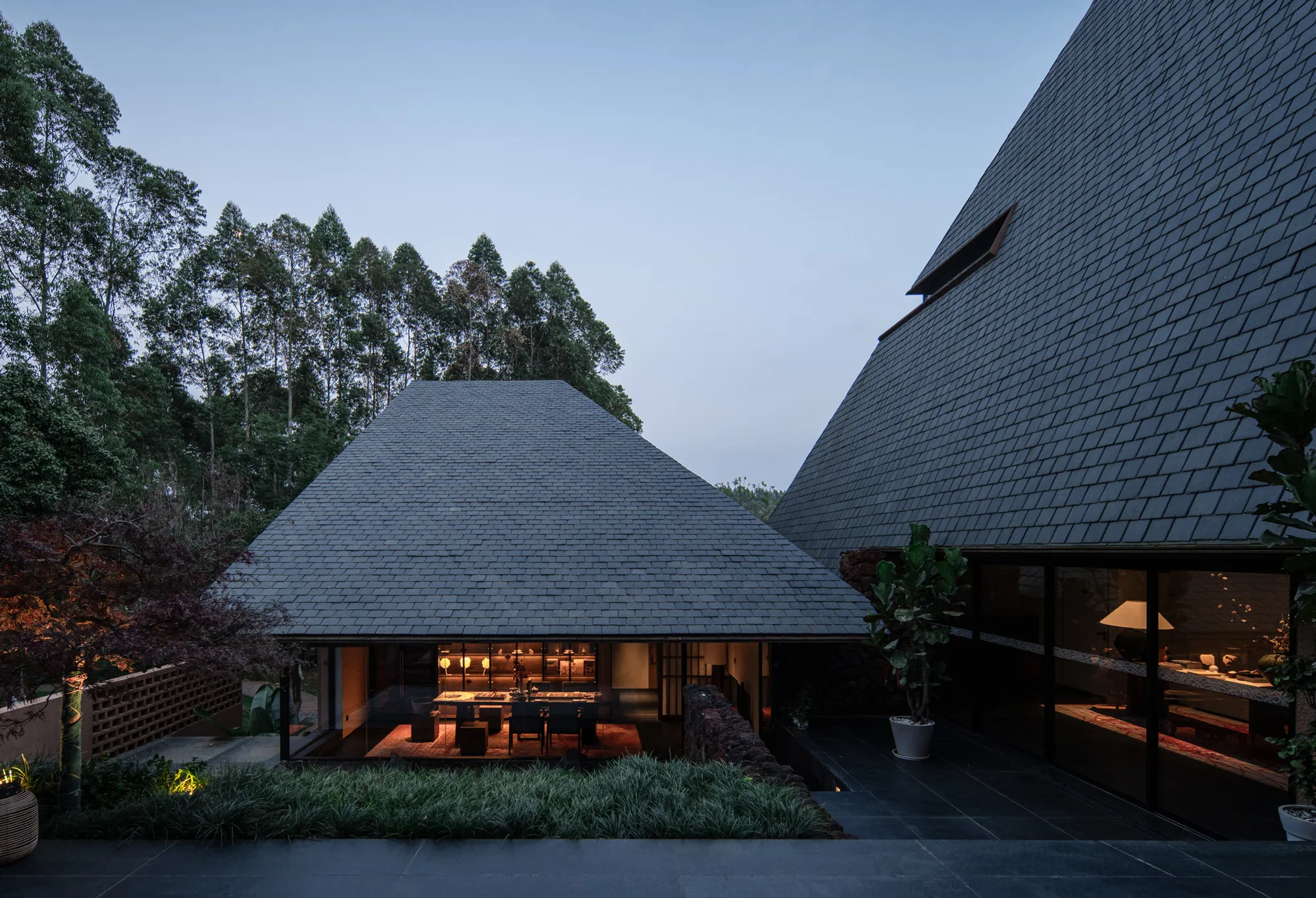 line+ and studio Scatter Steep-Roofed Dwellings Across a Red Valley in Yunnan